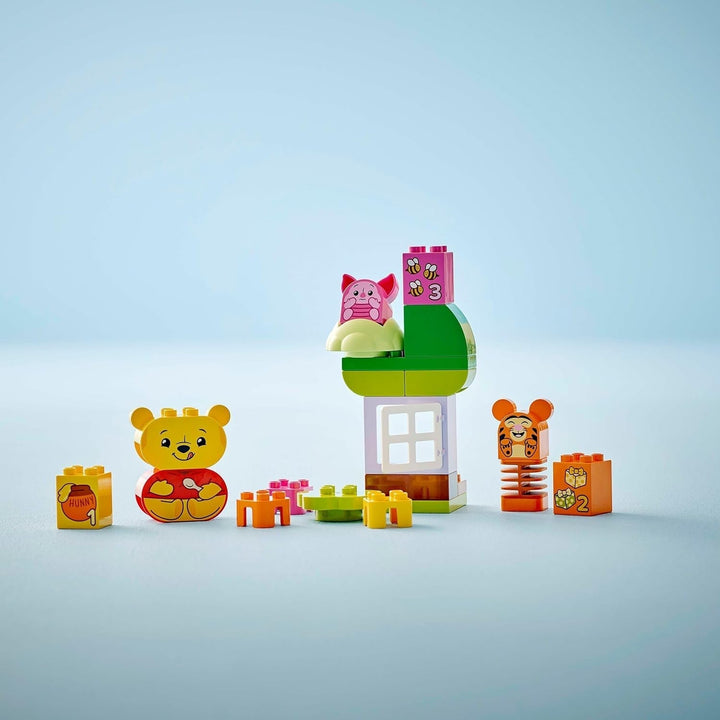 LEGO DUPLO - Disney Winnie the Pooh's Birthday Party - jucărie educativă pentru preșcolari - set cu 3 minifigurine, inclusiv Winnie the Pooh, Tigger și Piglet - idee de cadou pentru băieți și fete de la 1,5 ani 10457 Seturi de constructie Besuche den LEGO-Store